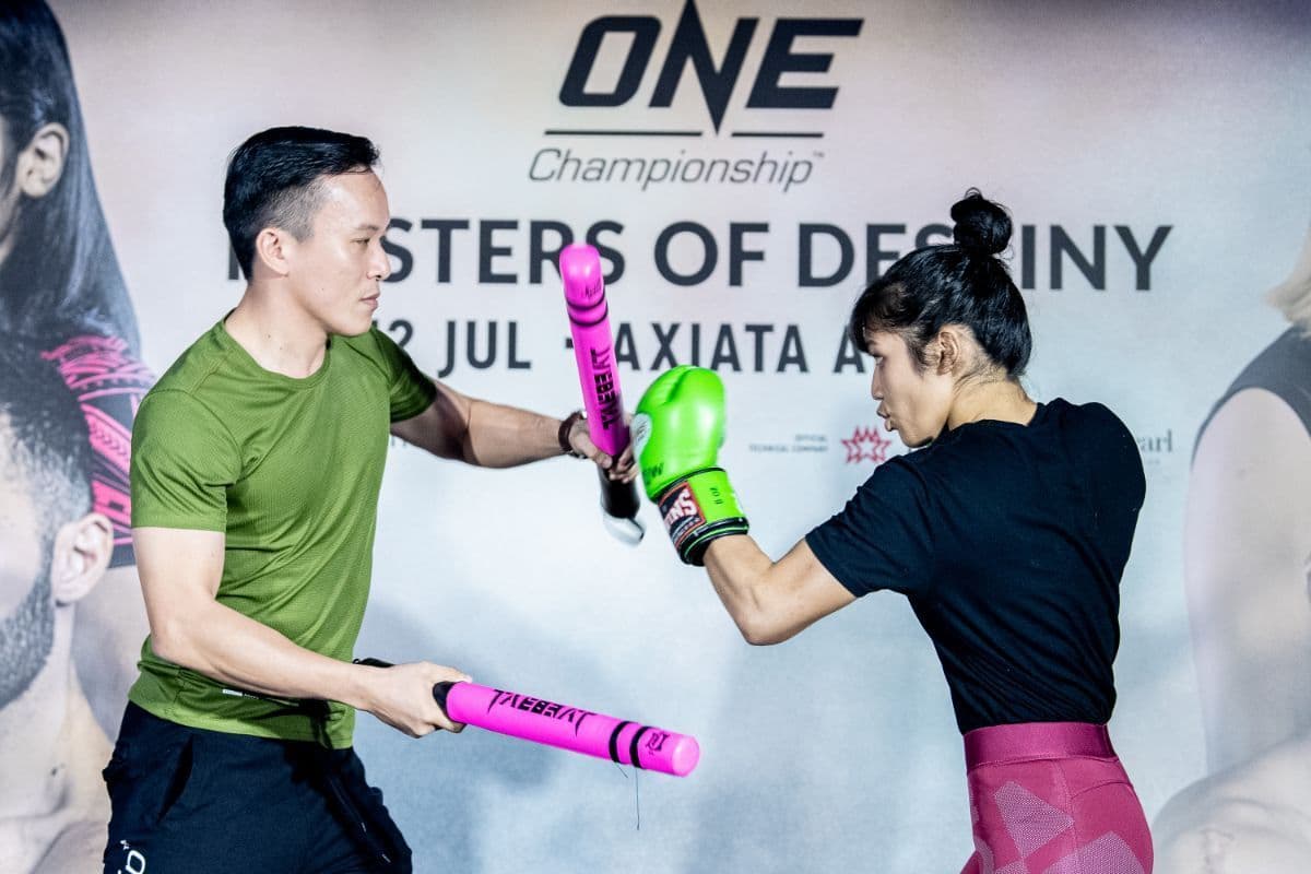 Melvin Yeoh holding striking targets for Jihin 'Shadow Cat' Radzuan at a ONE Championship open workout